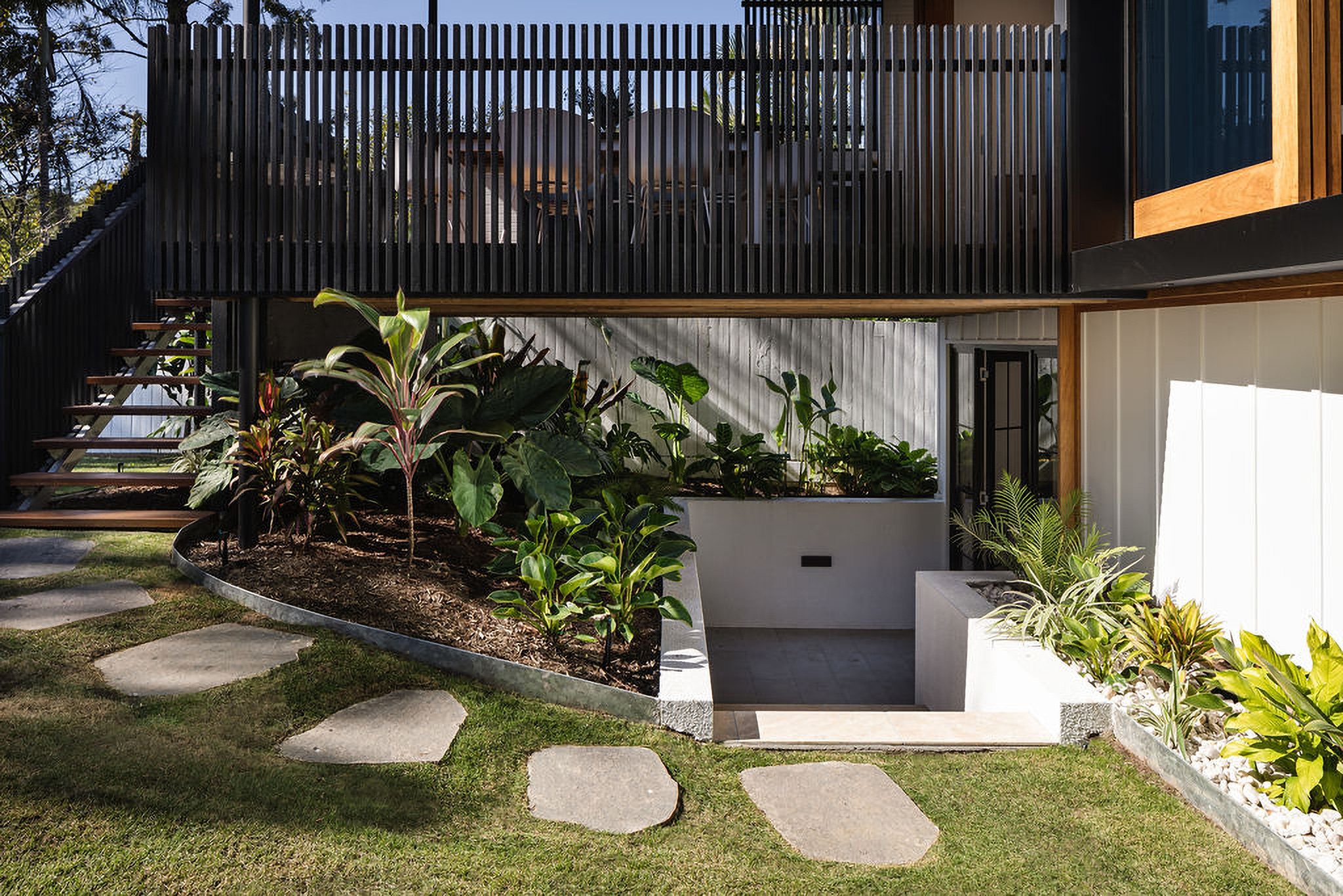 Undercroft garden beneath the timber screen